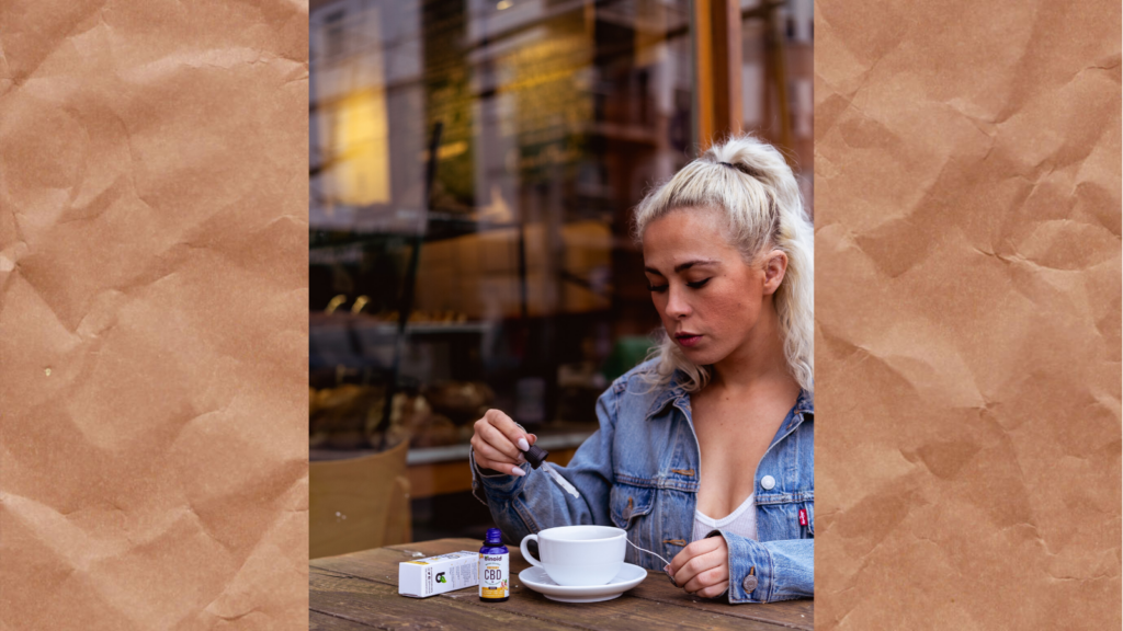 A photo of a woman dripping CBD oil into a coffee mug.