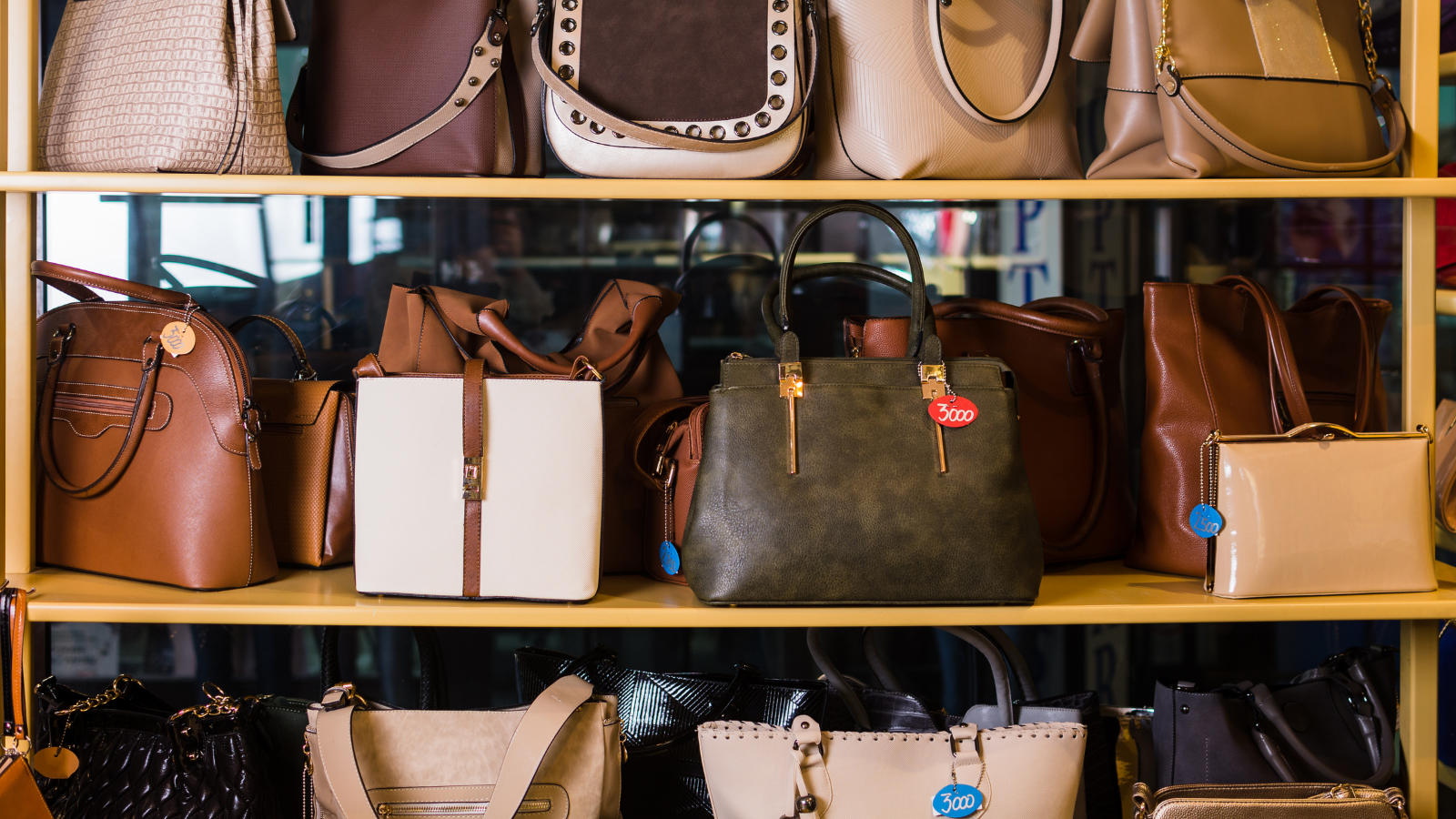 A photo of shelves displaying handbags.