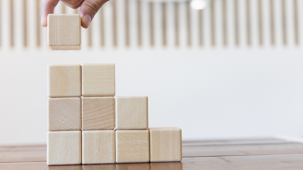 A photo of wooden blocks being stacked to form stairs.