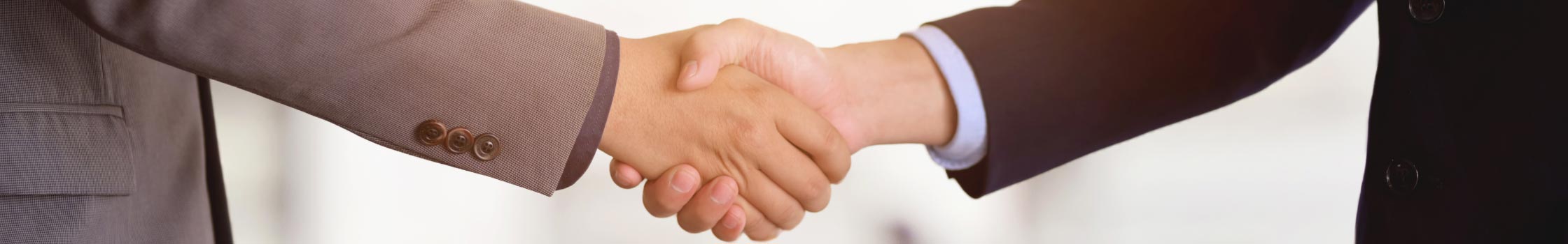 A photo of individuals shaking hands.